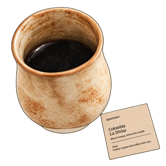 Apartment Coffee’s mottled tan ceramic cup of black coffee beside its Colombia La Divisa coffee card