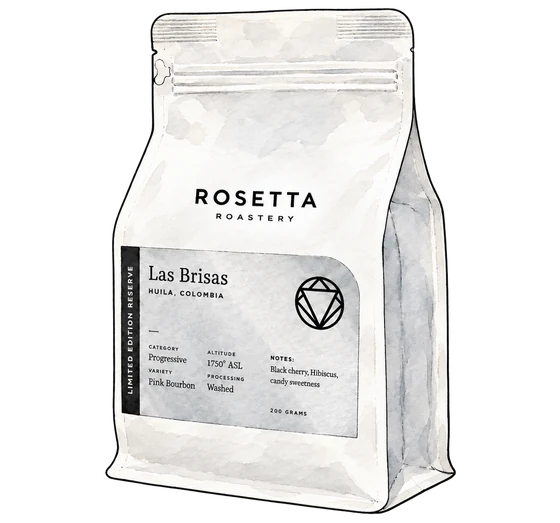 Rosetta's white Las Brisas coffee bag with a silver label, black wordmark and circular faceted emblem